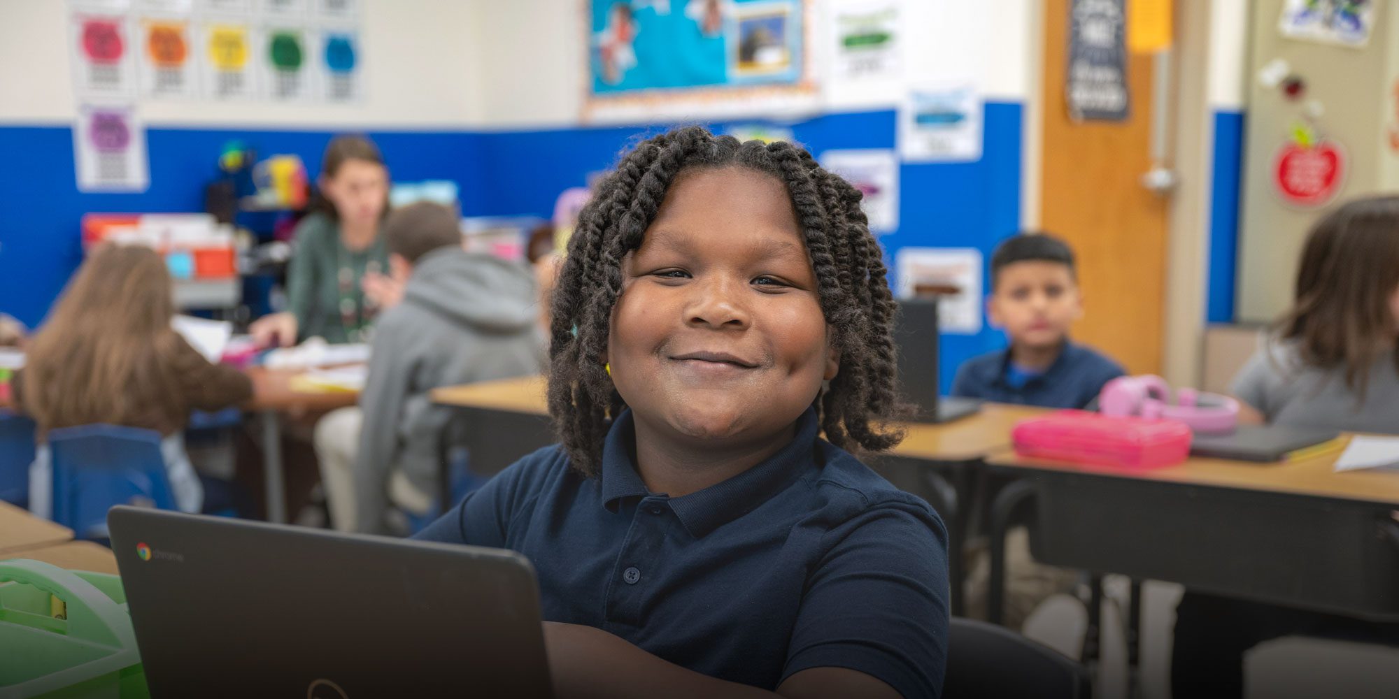 Smiling student working on computer